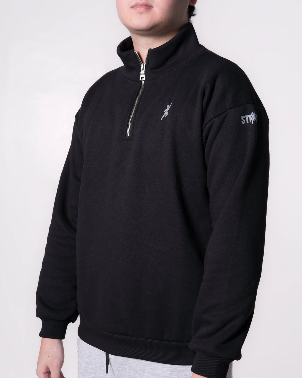 Person wearing a Black pullover with logos on a white background
#color_black