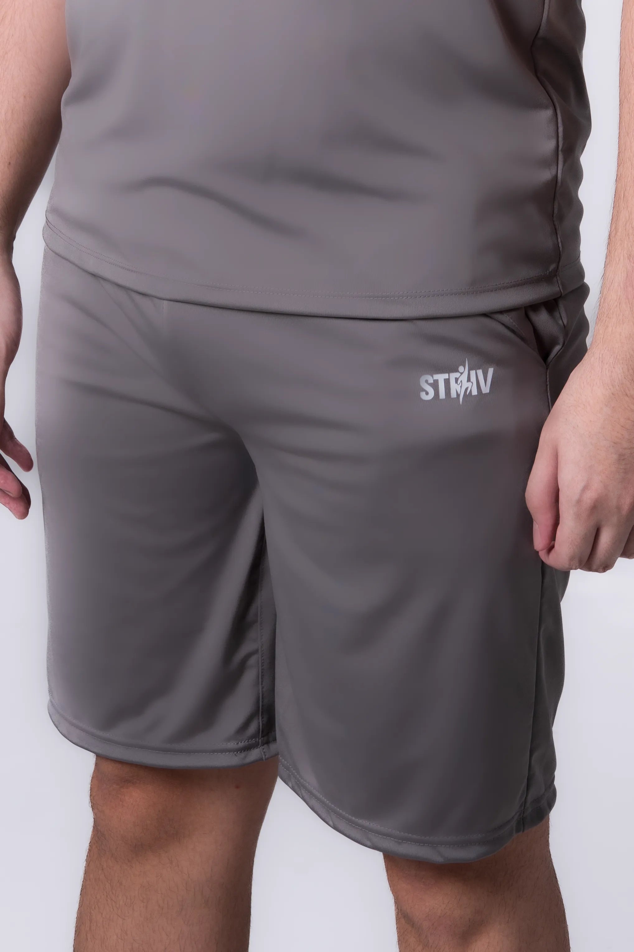 Person wearing Gray athletic shorts with a brand logo on a plain background
#color_gray