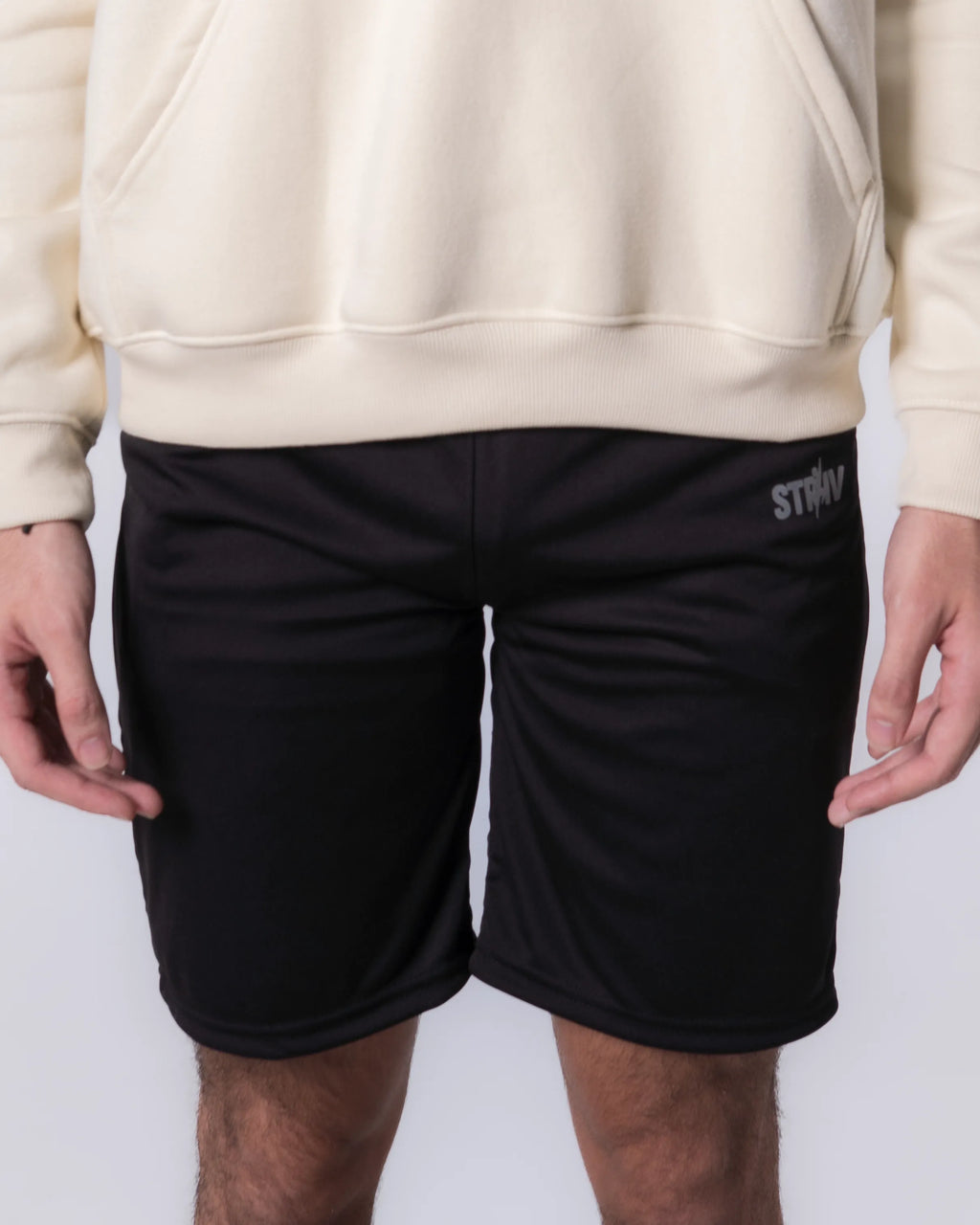 Person wearing Black shorts with a brand logo on a white background
#color_black