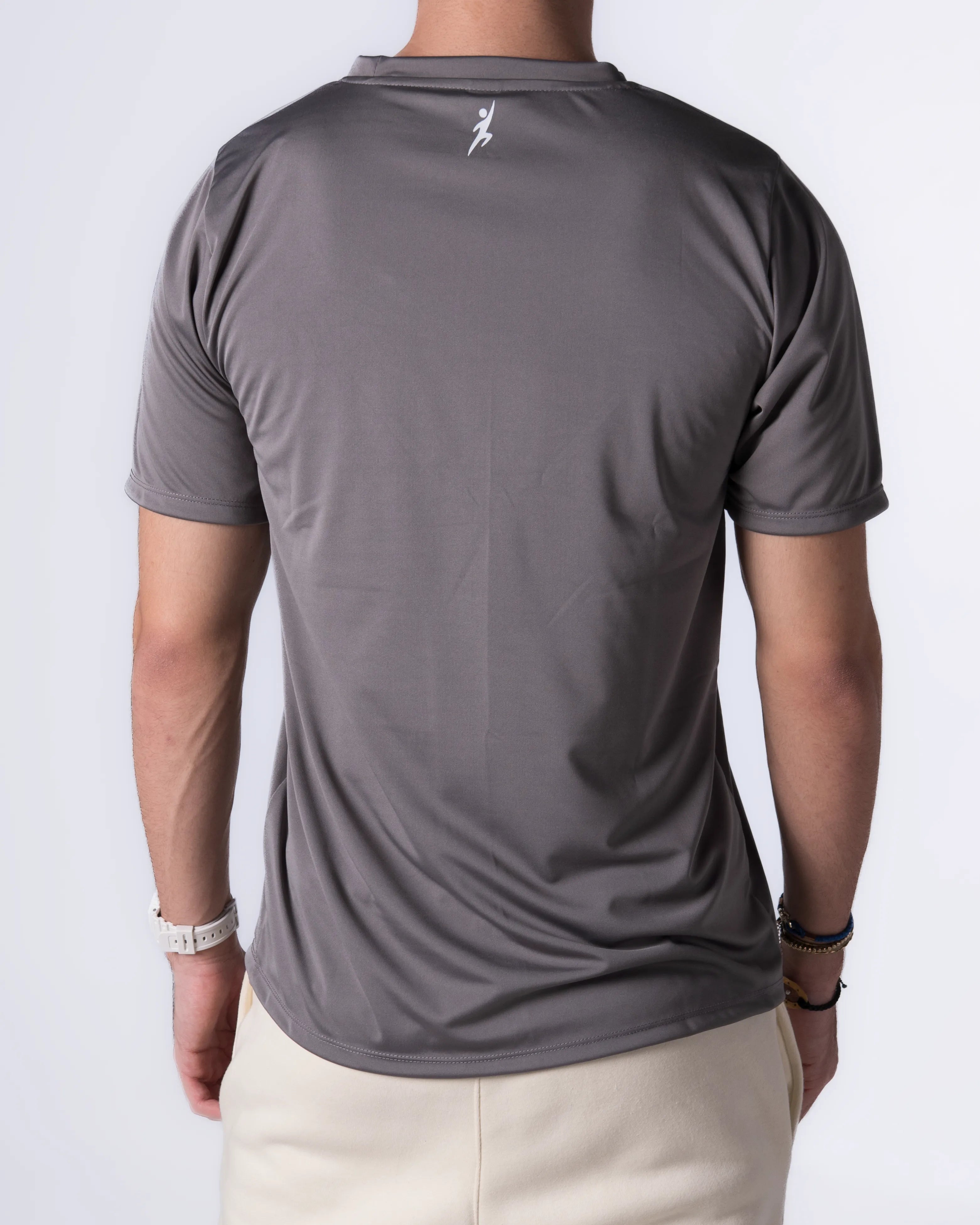 Person wearing a Gray athletic shirt with a logo on the back against a white background
#color_gray